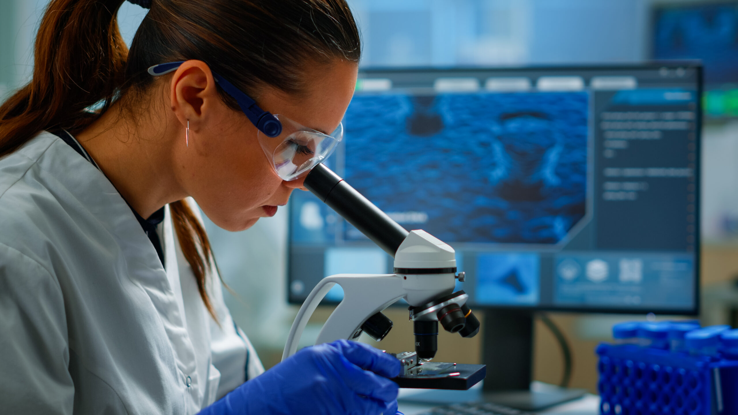 Researcher looking through a microscope